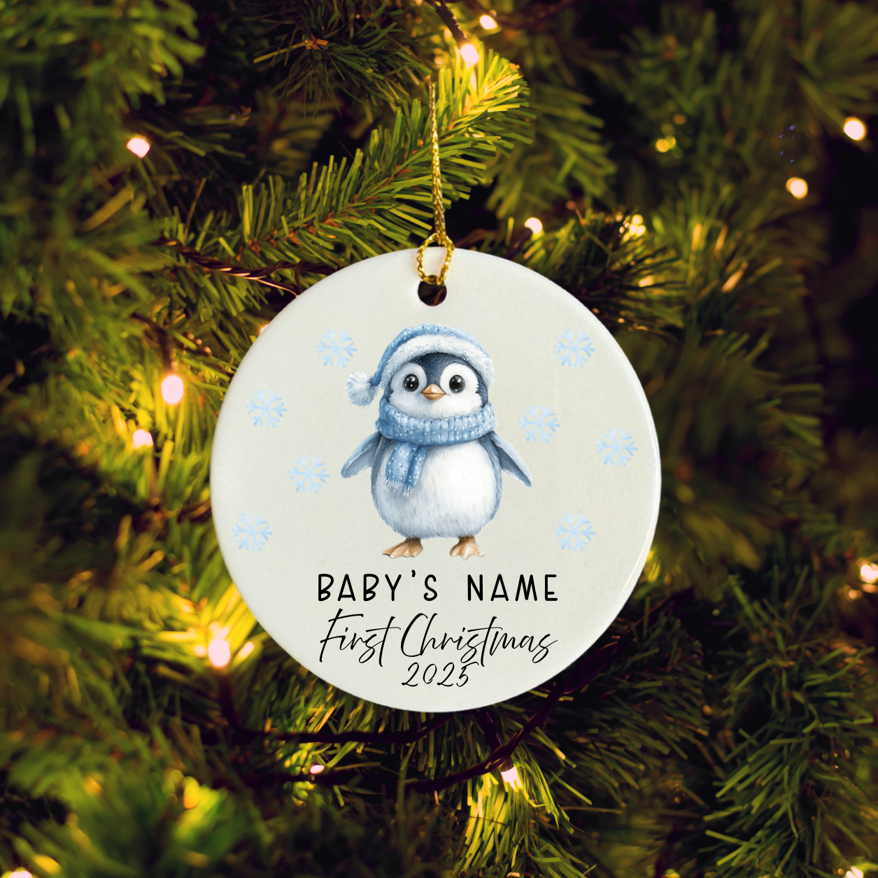 Christmas ornament with penguin design hanging on a tree