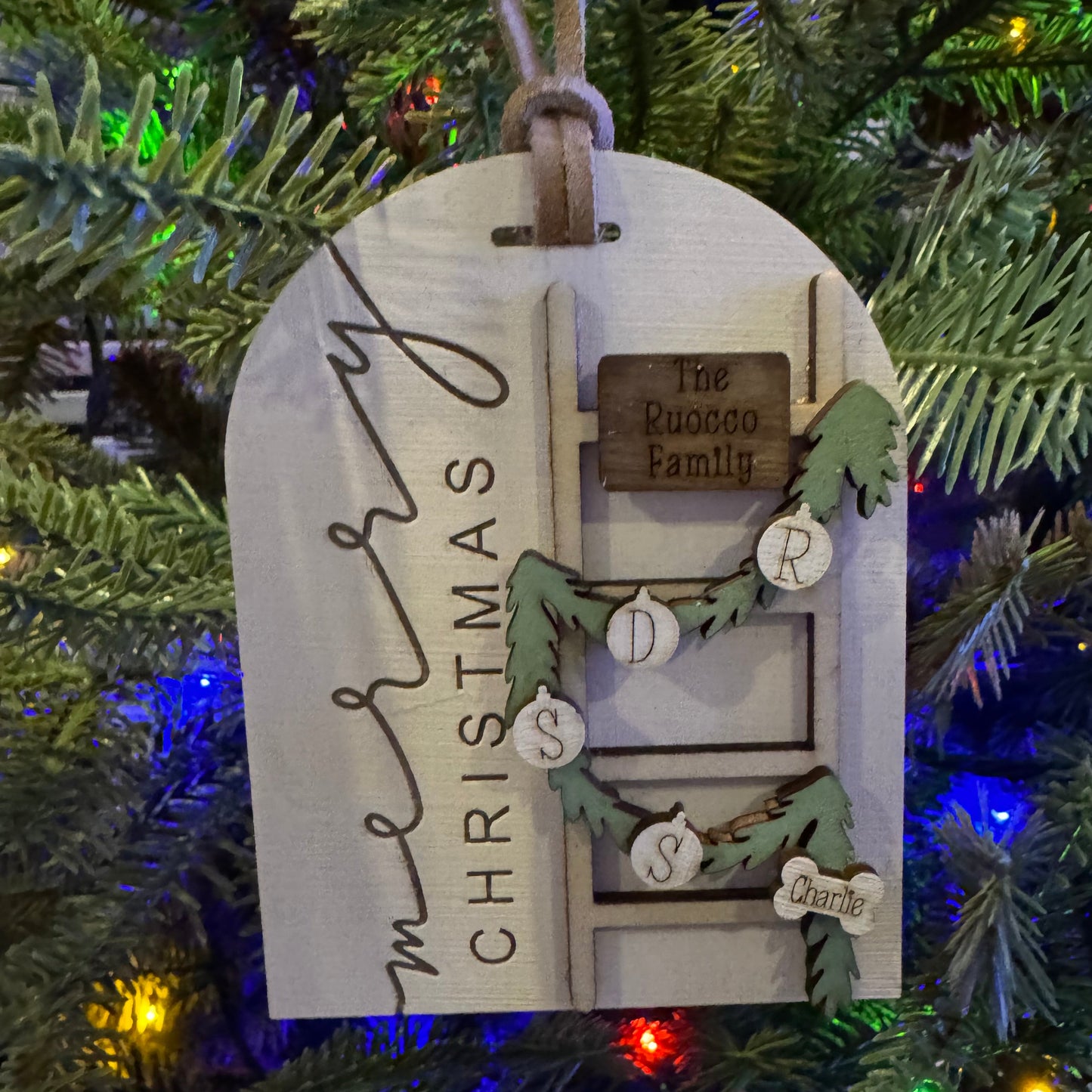 Decorative Christmas tag on a Christmas tree with personalized text.