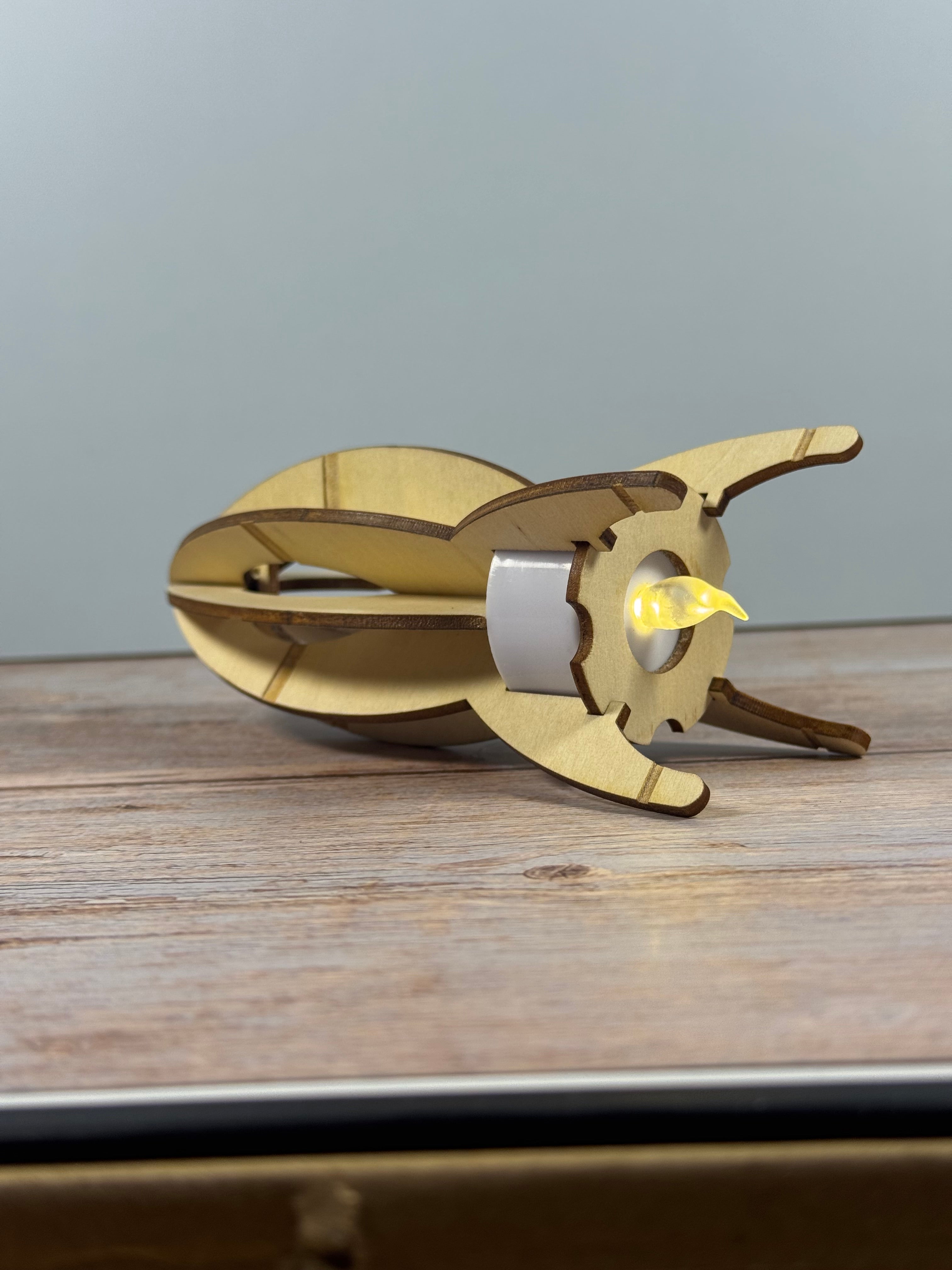 Wooden rocket  puzzle toy with battery tea light for a booster.