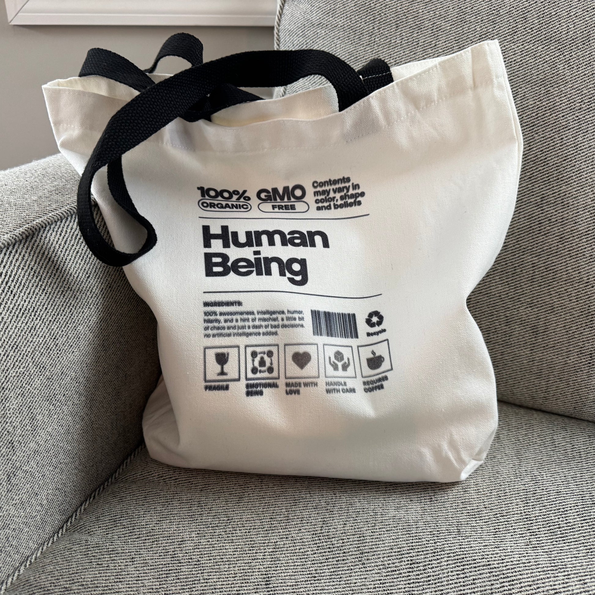 100% Human Tote lifestyle use on a grey chair