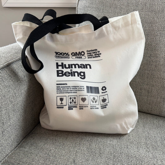 100% Human Tote lifestyle use on a grey chair