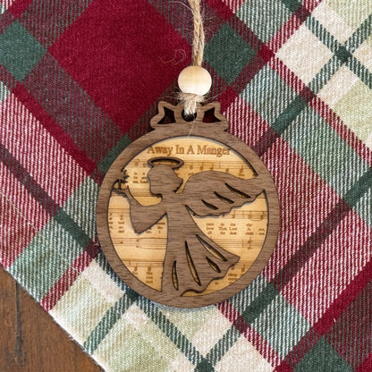 Wooden angel ornament on a plaid fabric background