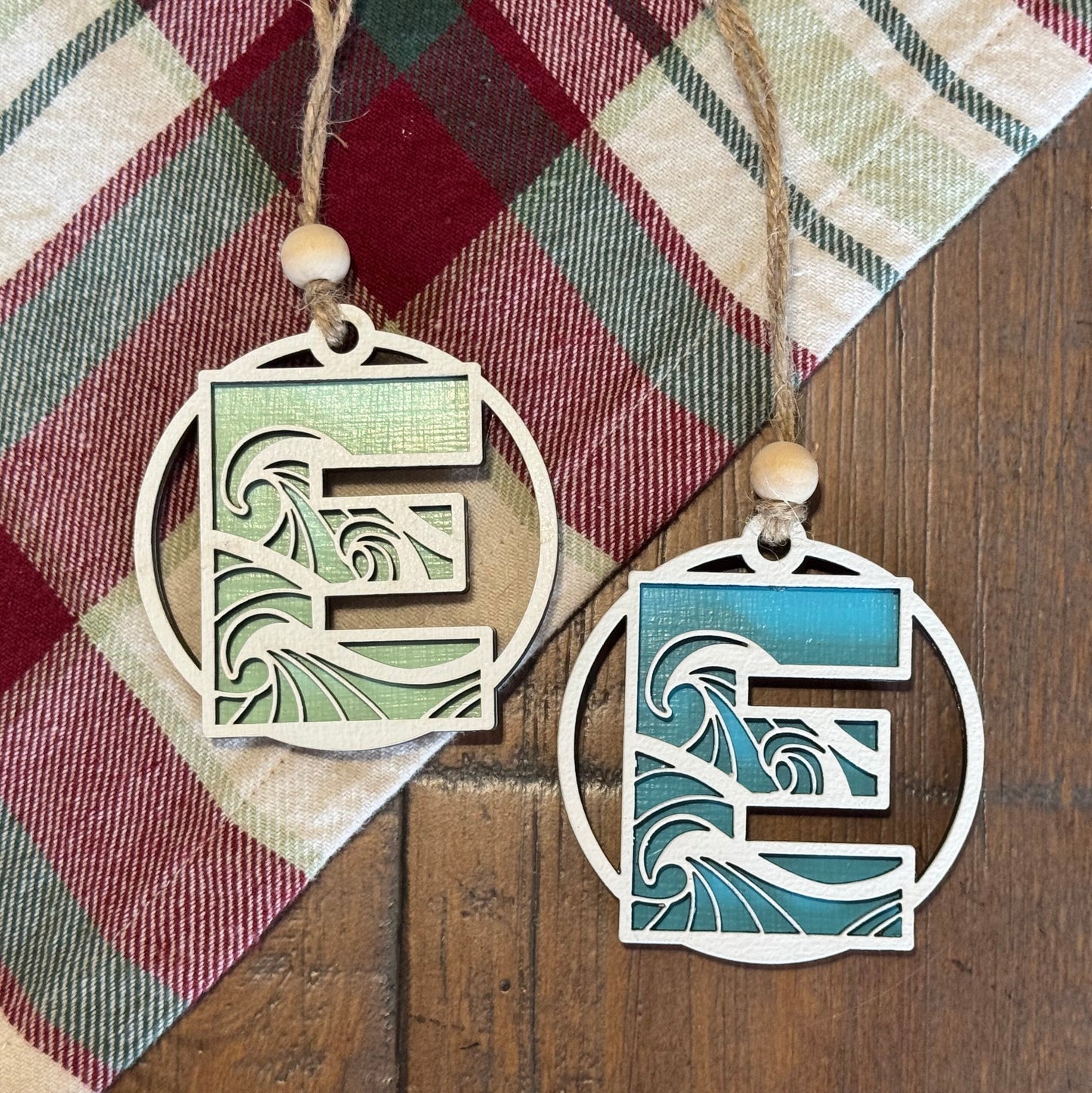 Layered Wave Letter Ornaments on a plaid fabric background