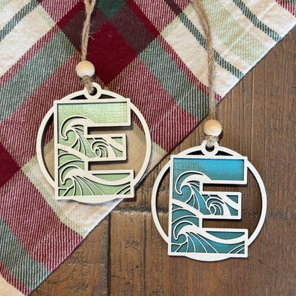 Layered Wave Letter Ornaments on a plaid fabric background