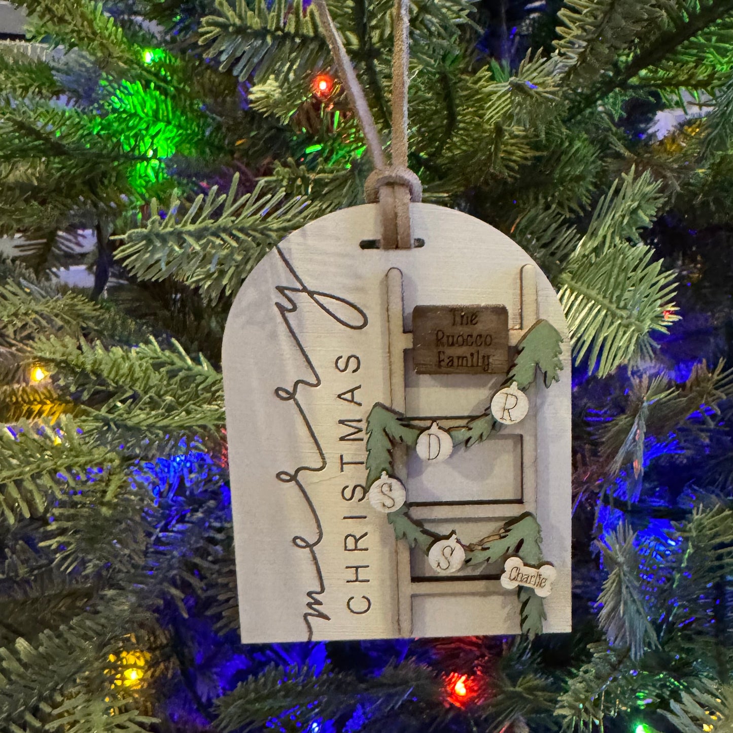 Decorative Christmas ornament on a tree with colorful lights