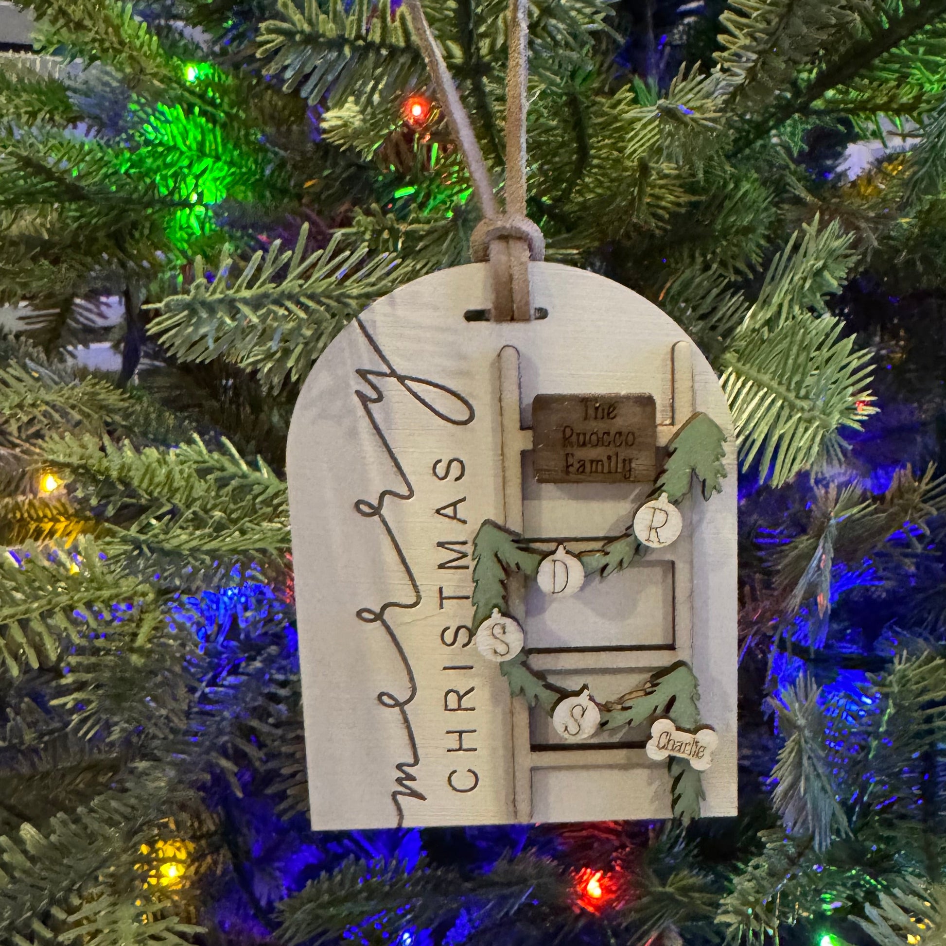 Decorative Christmas ornament on a tree with colorful lights