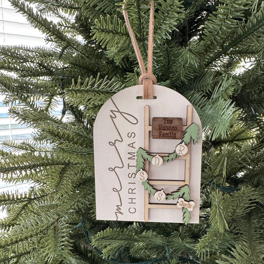 Decorative Christmas tag with a ladder design hanging on a Christmas tree.