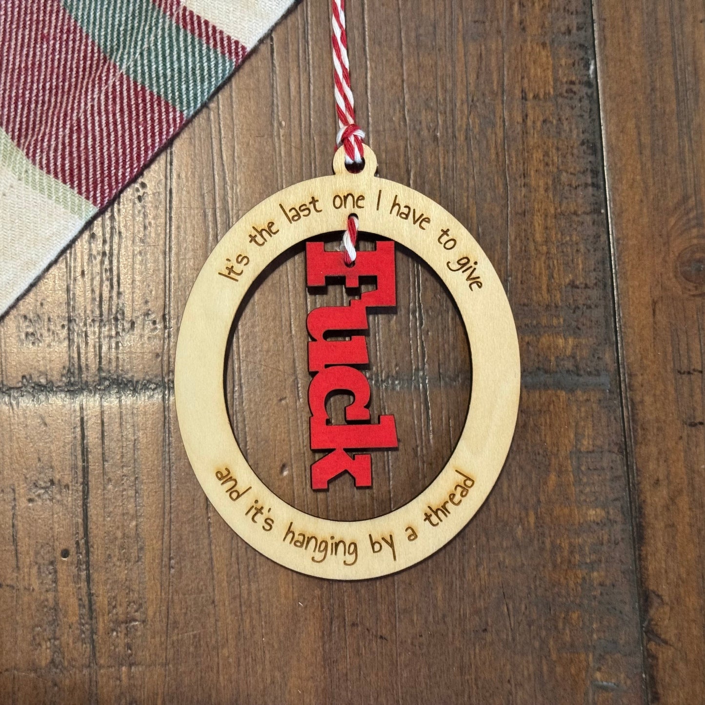 Decorative ornament with text on a wooden surface