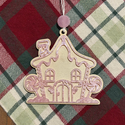 Decorative house ornament on a plaid fabric background