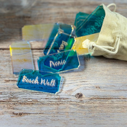 Acrylic tokens with activities engraved in surface. Fabric bag holder.