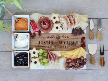 Personalized cheeseboard with assorted meats, cheeses, fruits, and accompaniments on a wooden board.