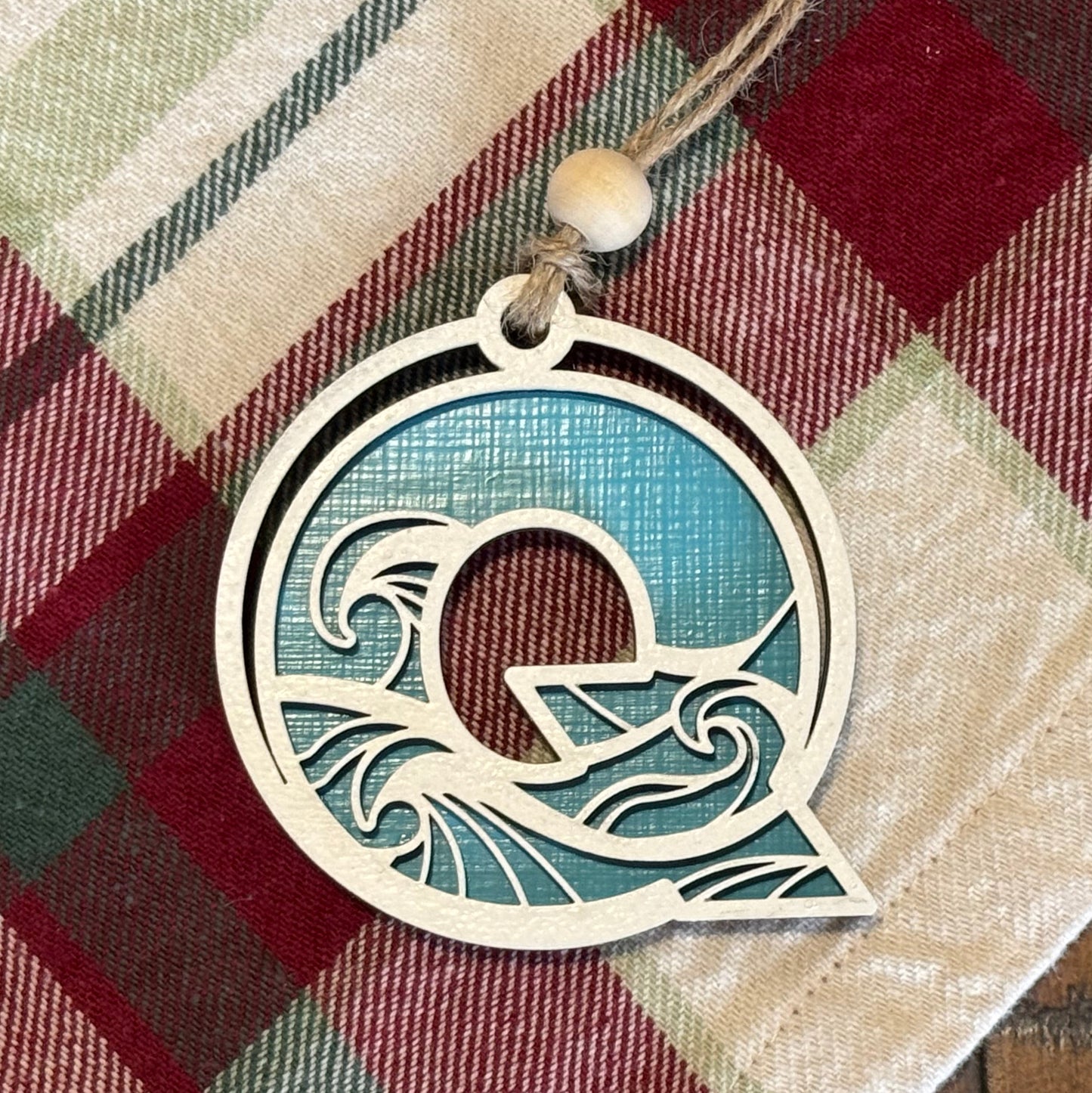 Layered Wave Letter Ornament on a plaid fabric background