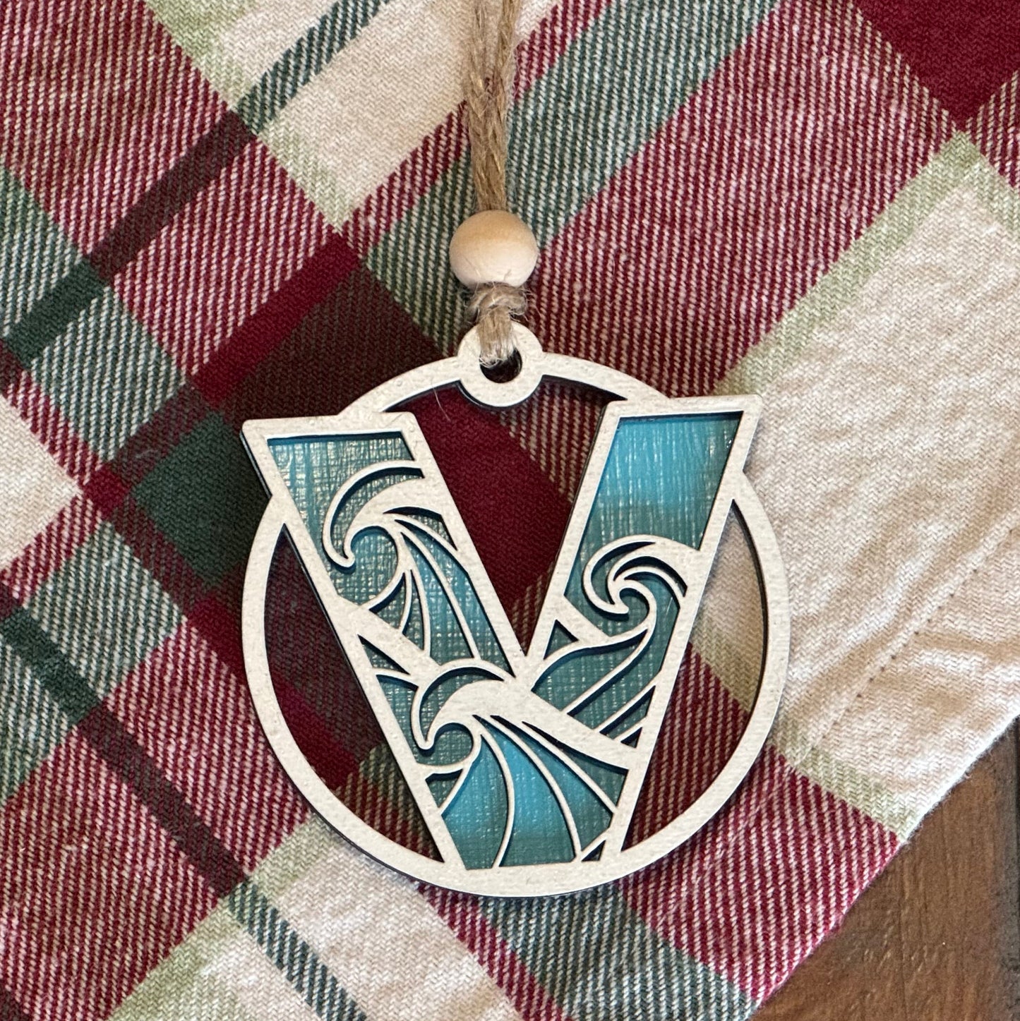Layered Wave Letter Ornament on a plaid fabric background