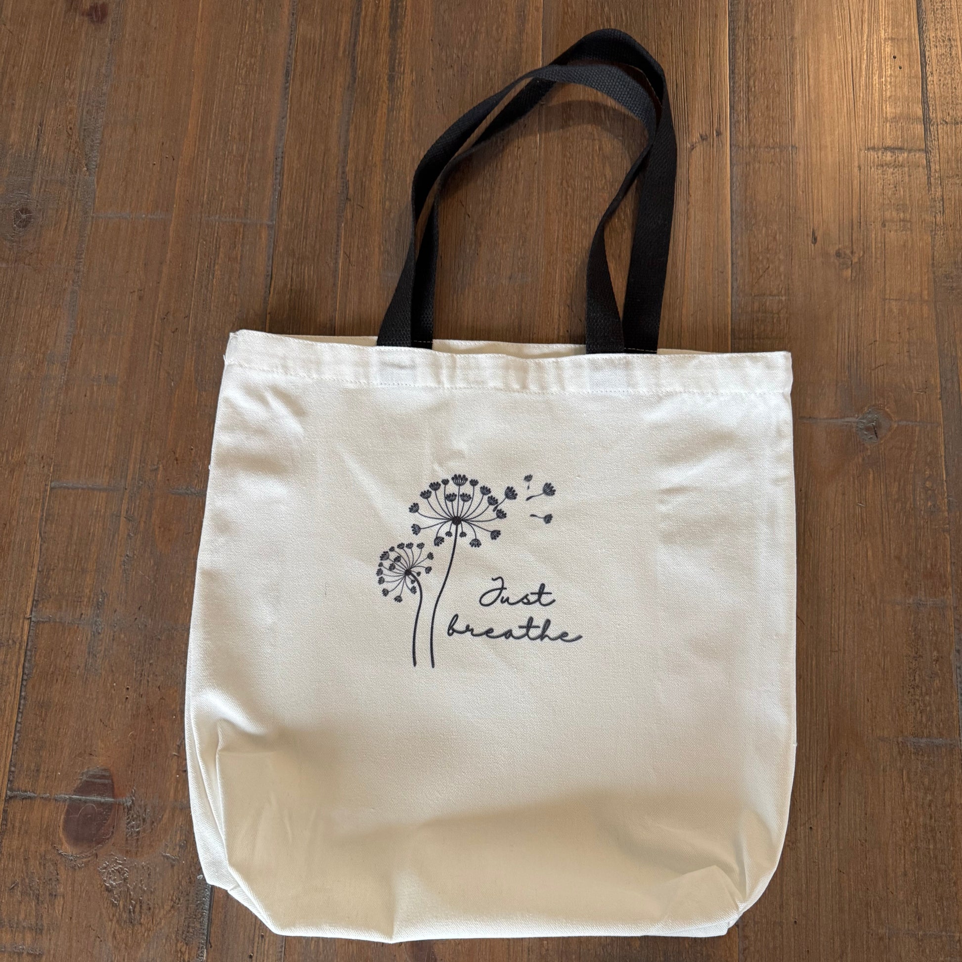 tote bag with black handle on a wooden surface