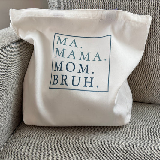 Ma Mama Mom Bruh Canvas Tote on a grey chair