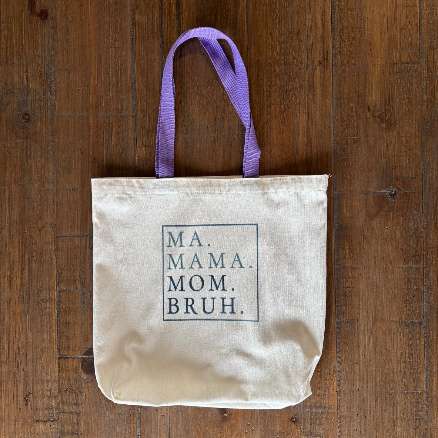 tote bag with text on a wooden surface