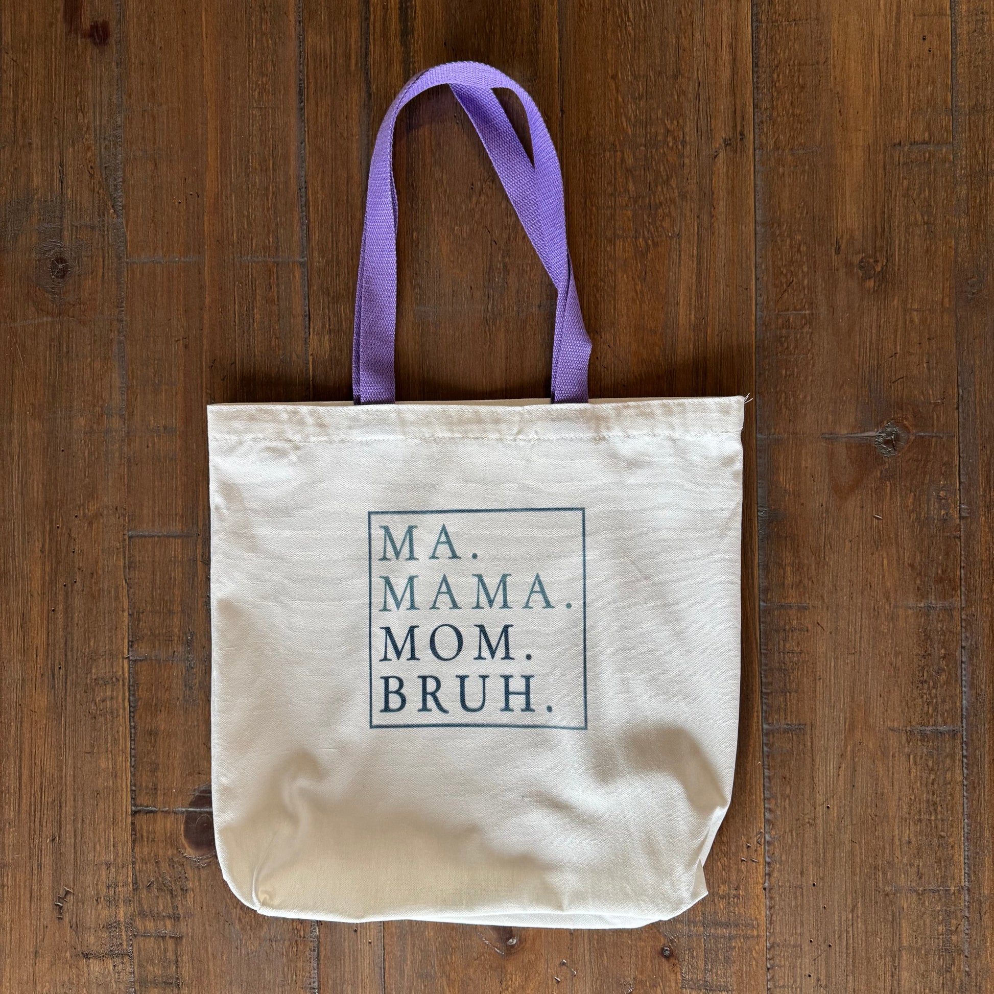 tote bag with text on a wooden surface