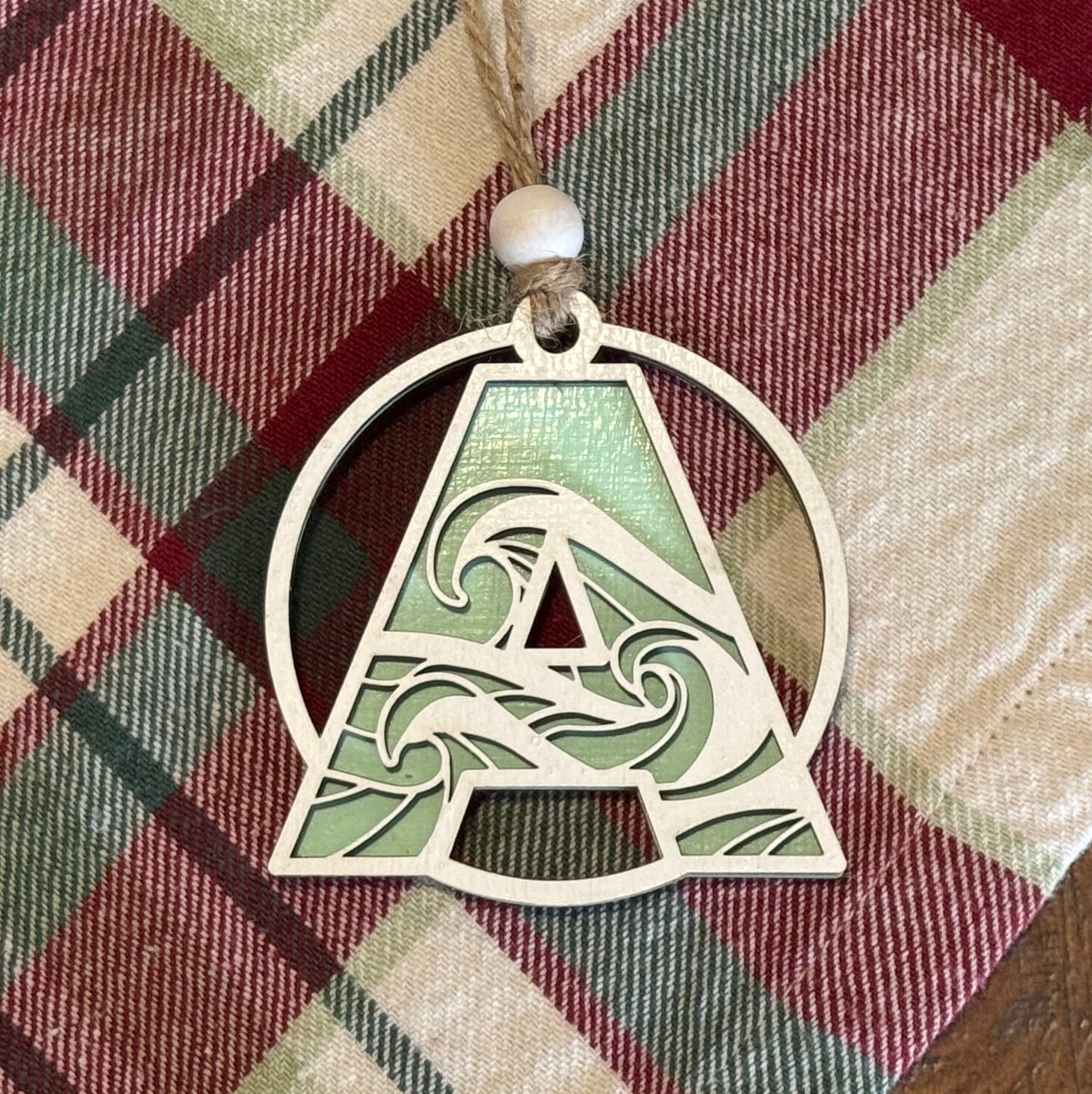 Wave Letter Ornament on plaid fabric background