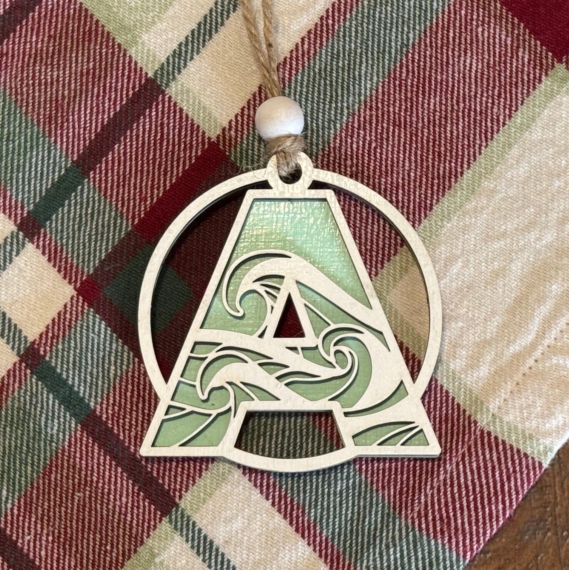 Wave Letter Ornament on plaid fabric background