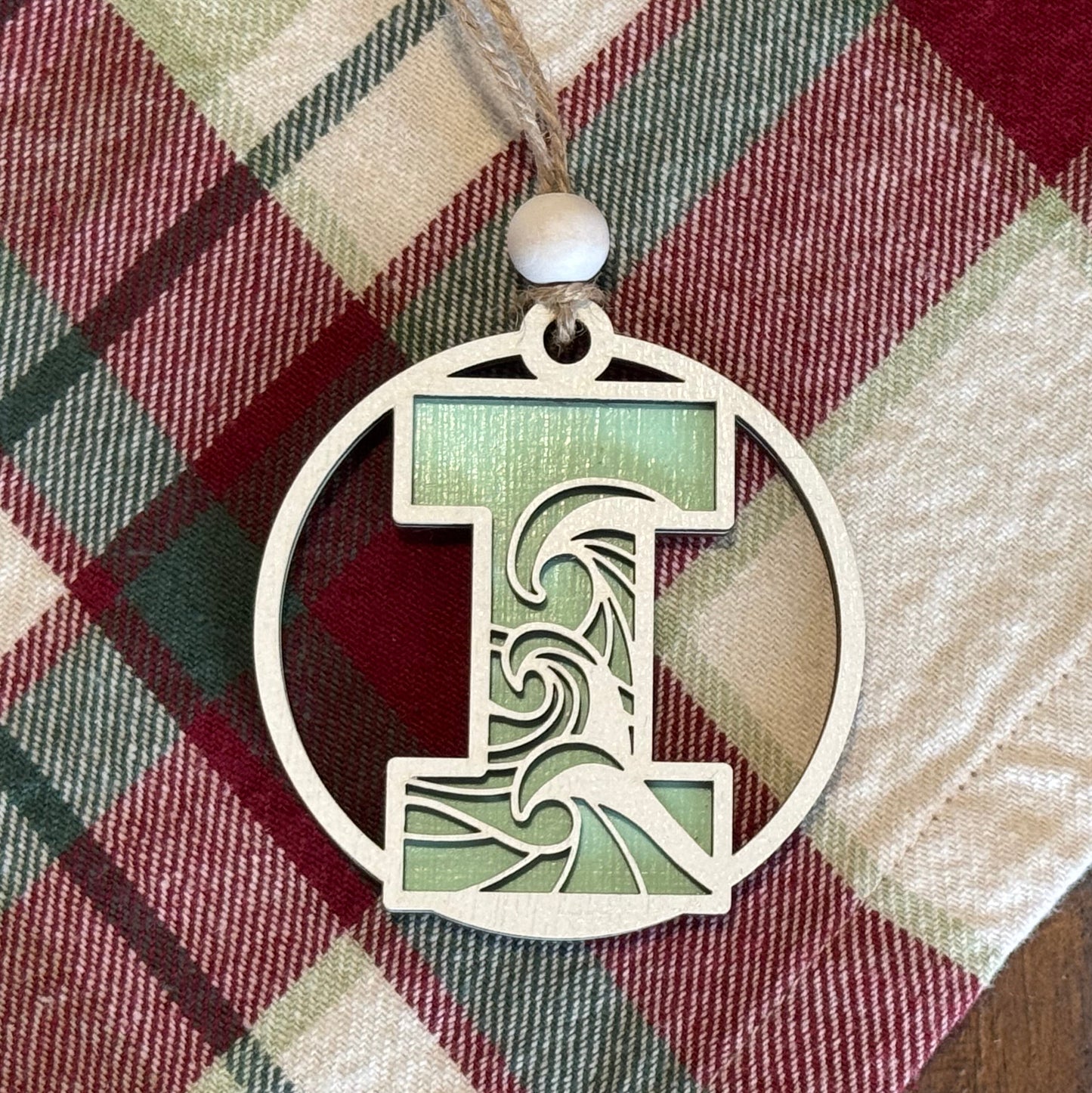 Layered Wave Letter Ornament on a plaid fabric background