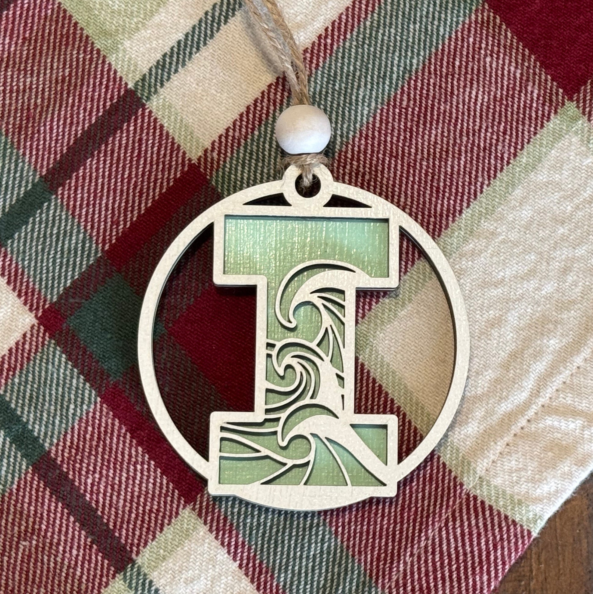 Layered Wave Letter Ornament on a plaid fabric background