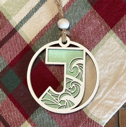 Layered Wave Letter Ornament on a plaid fabric background