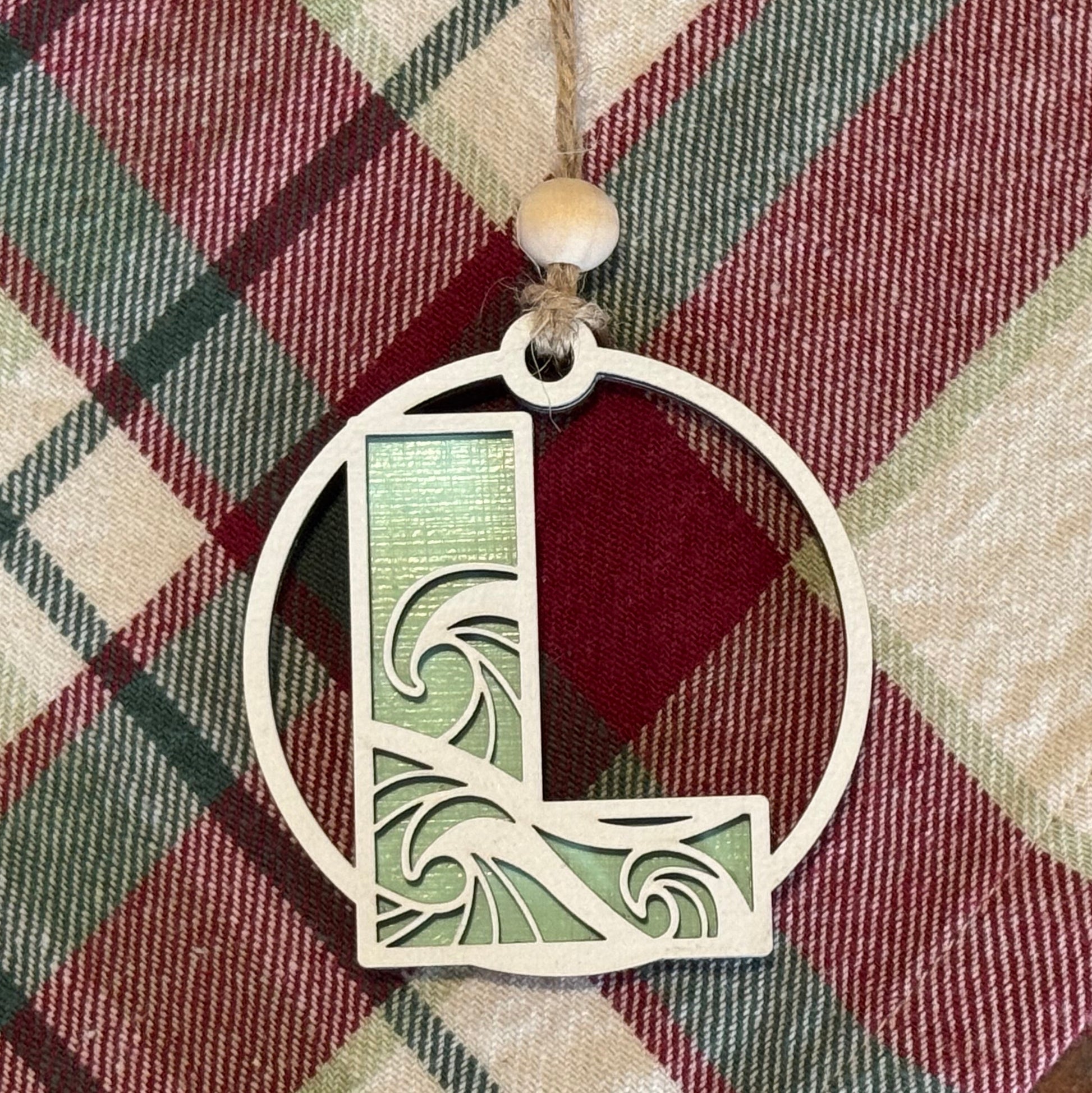 Layered Wave Letter Ornament on a plaid fabric background