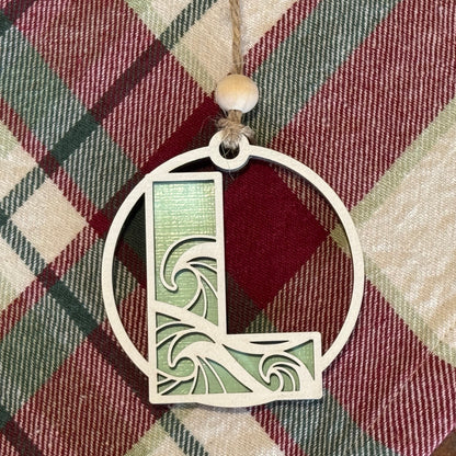 Layered Wave Letter Ornament on a plaid fabric background