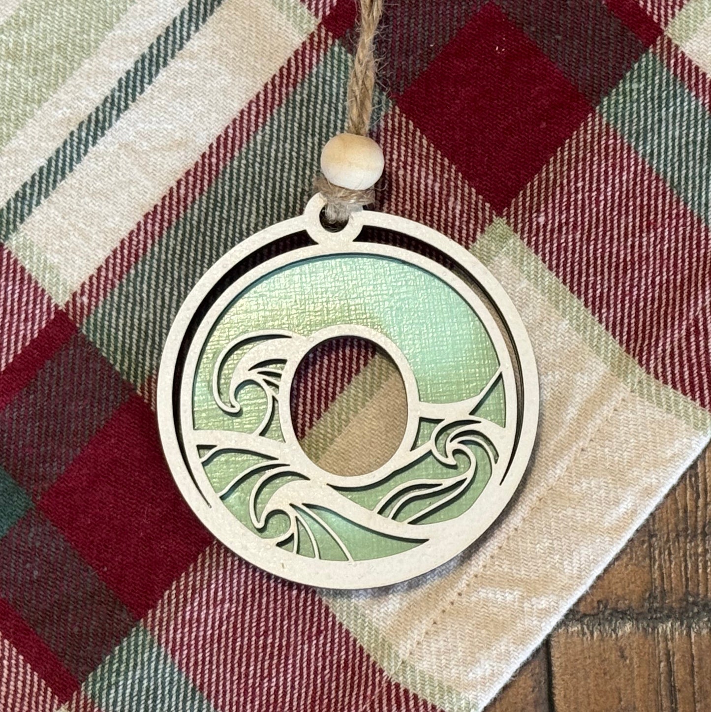 Layered Wave Letter Ornament on a plaid fabric background