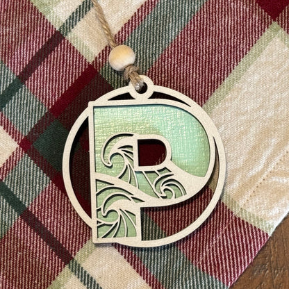 Layered Wave Letter Ornament on a plaid fabric background