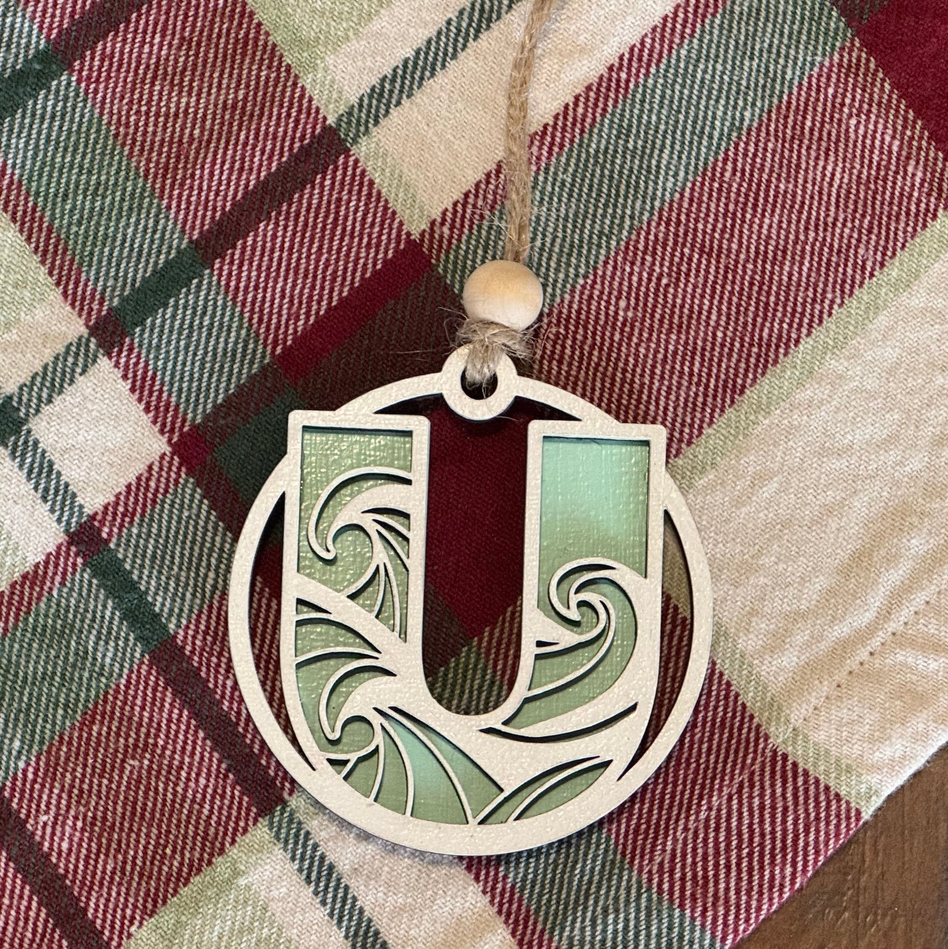 Layered Wave Letter Ornament on a plaid fabric background