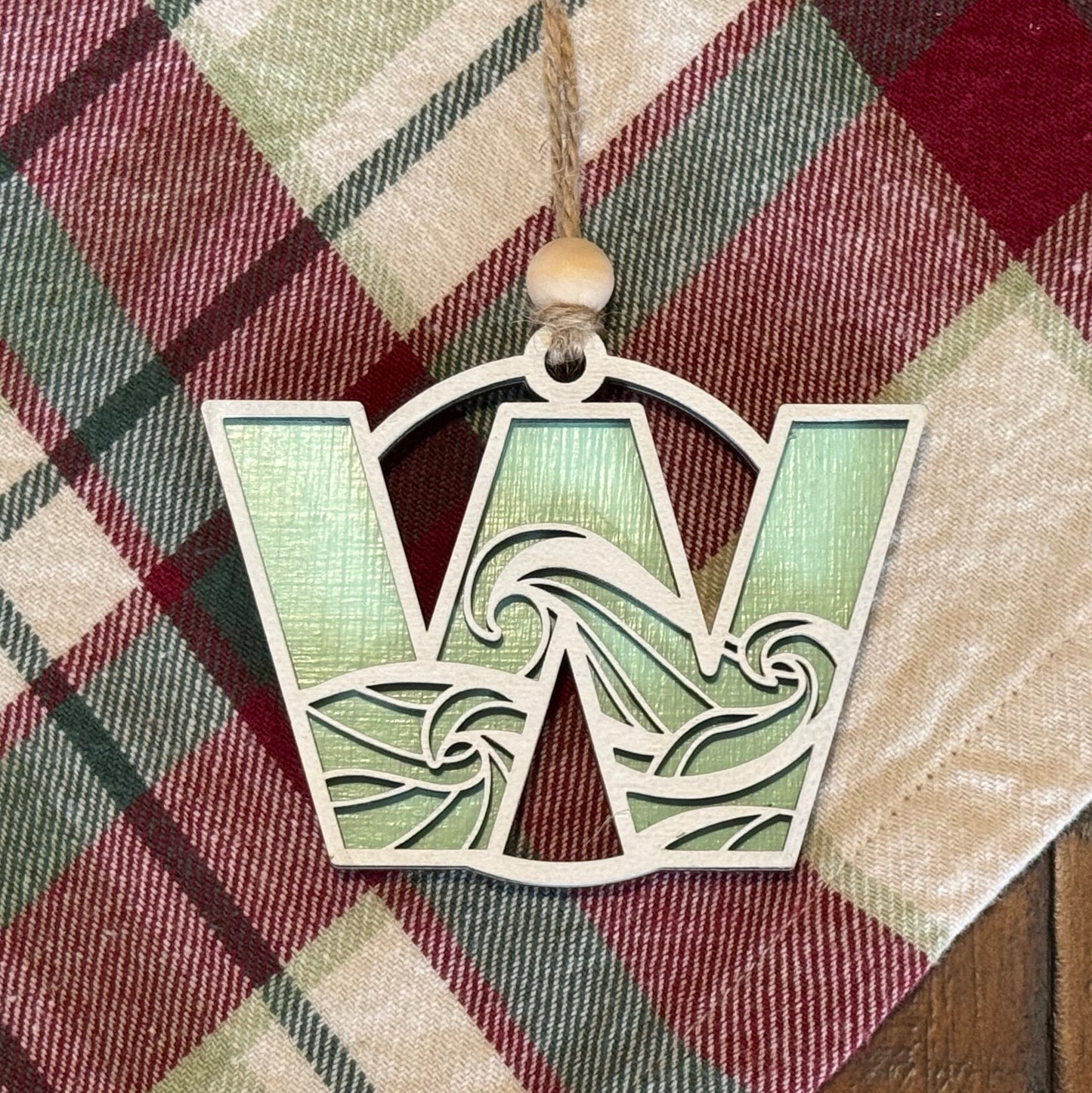 Layered Wave Letter Ornament on a plaid fabric background