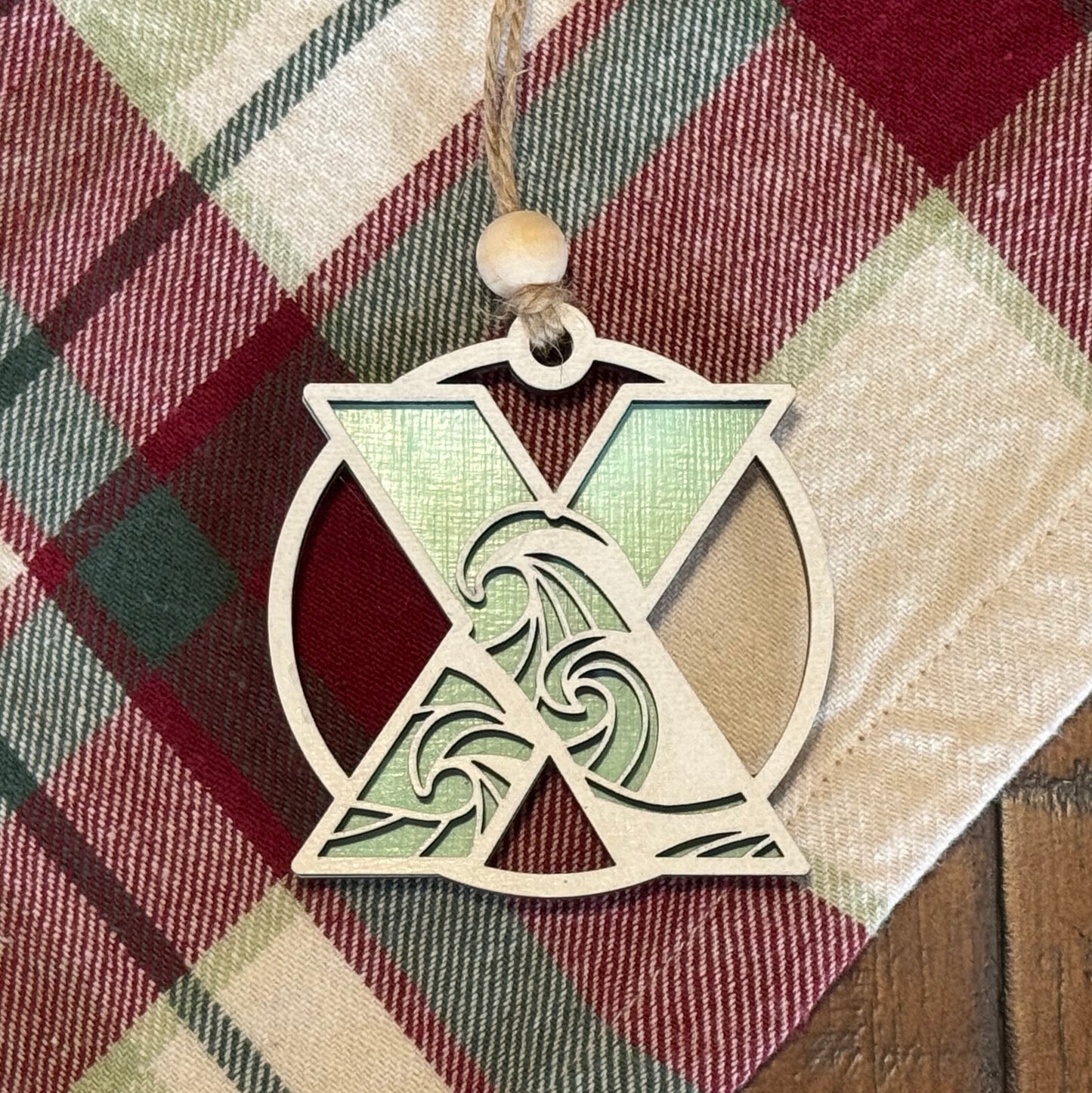 Layered Wave Letter Ornament on a plaid fabric background