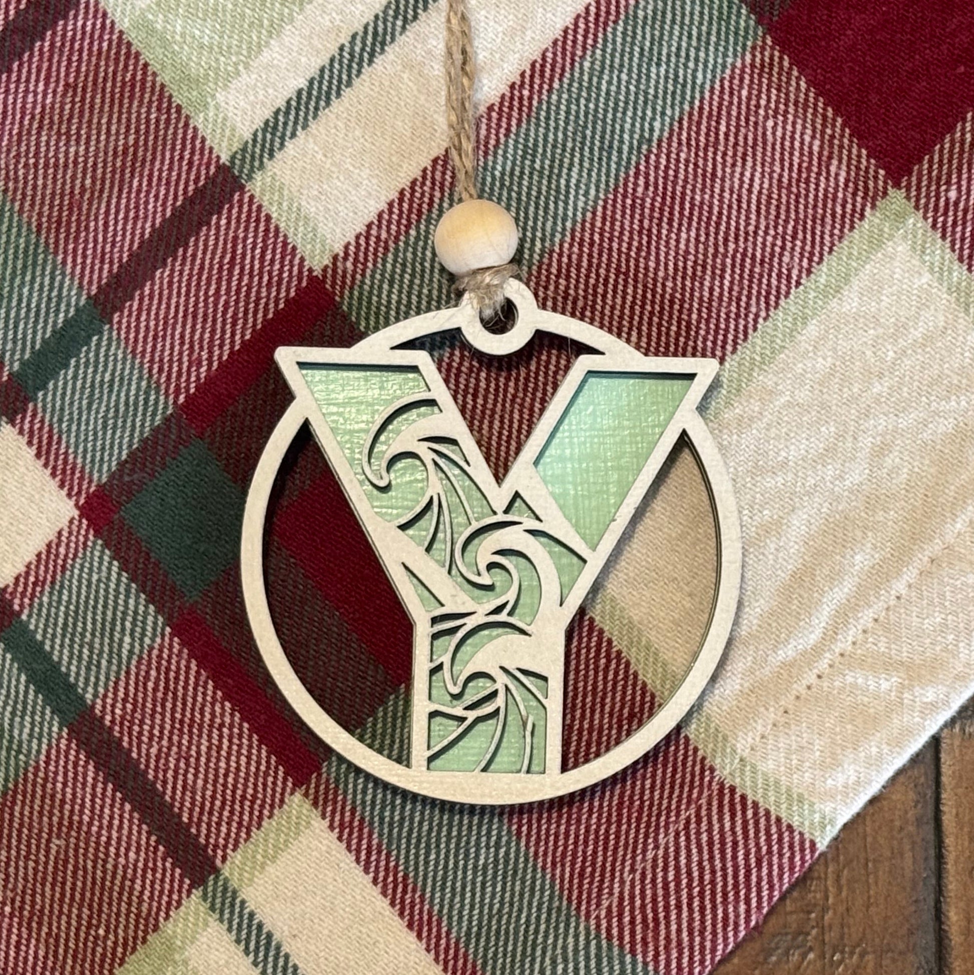 Layered Wave Letter Ornament on a plaid fabric background