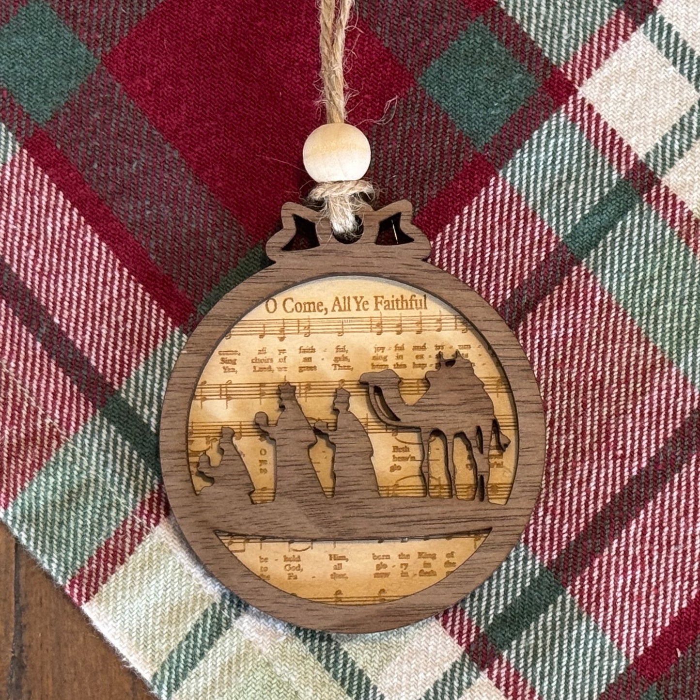 Wooden ornament with cut-out design on a plaid fabric background