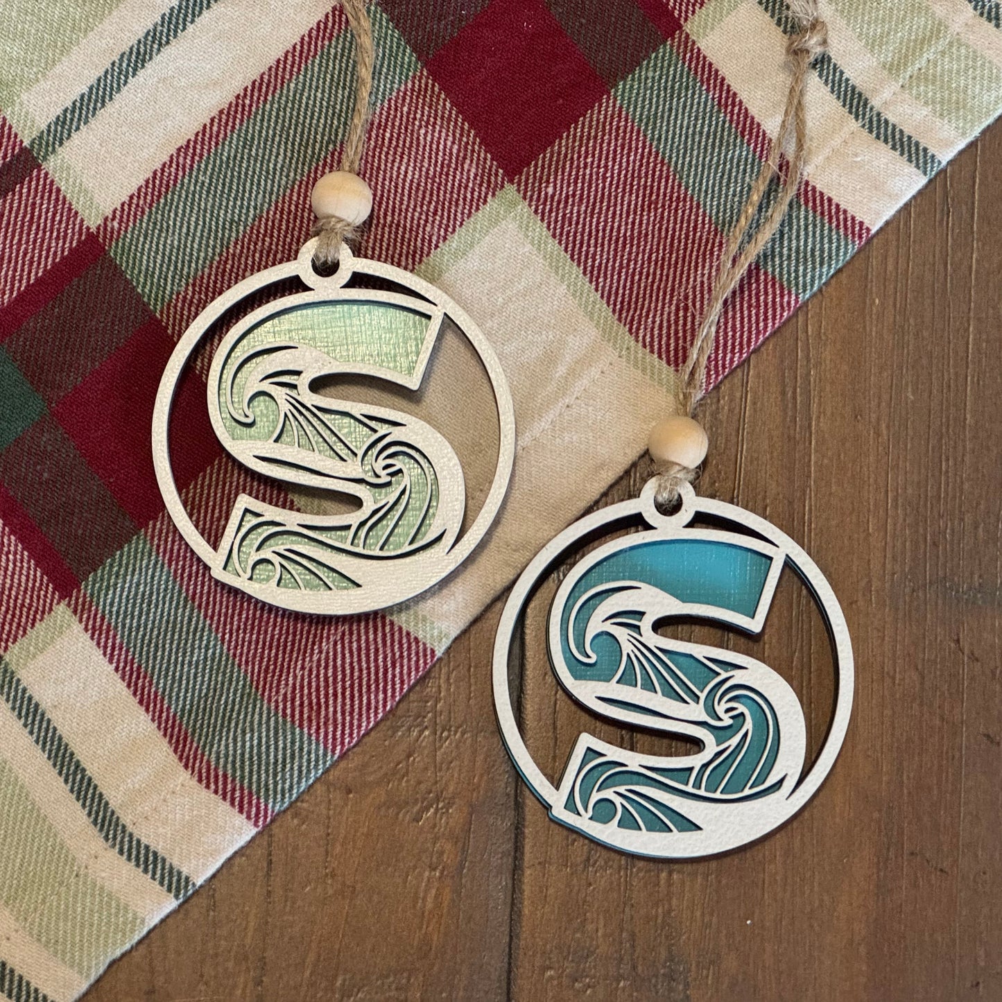 Layered Wave Letter Ornament on a plaid fabric background