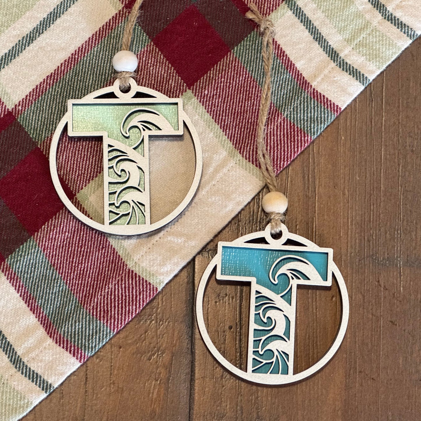 Layered Wave Letter Ornament on a plaid fabric background