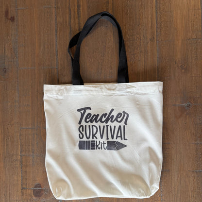 tote bag with 'Teacher Survival Kit' text on a wooden surface