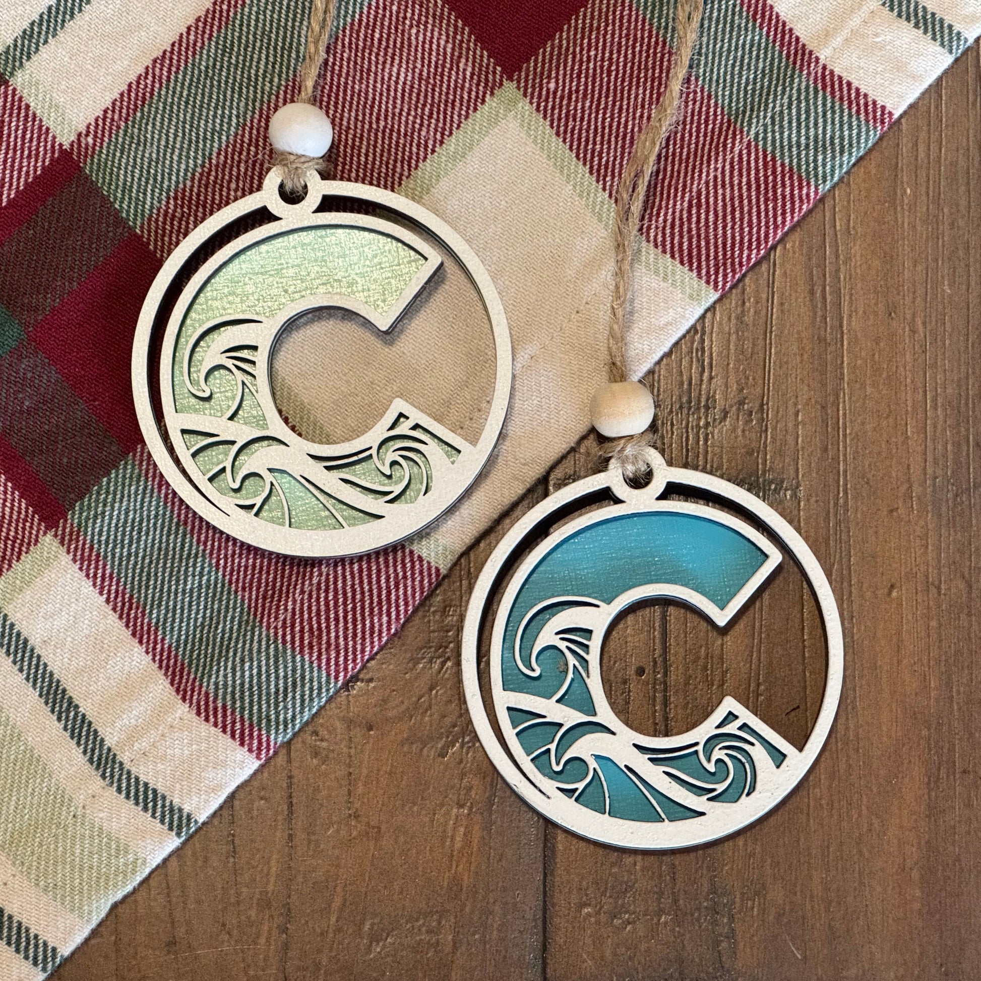 Layered Wave Letter Ornaments on a plaid fabric background